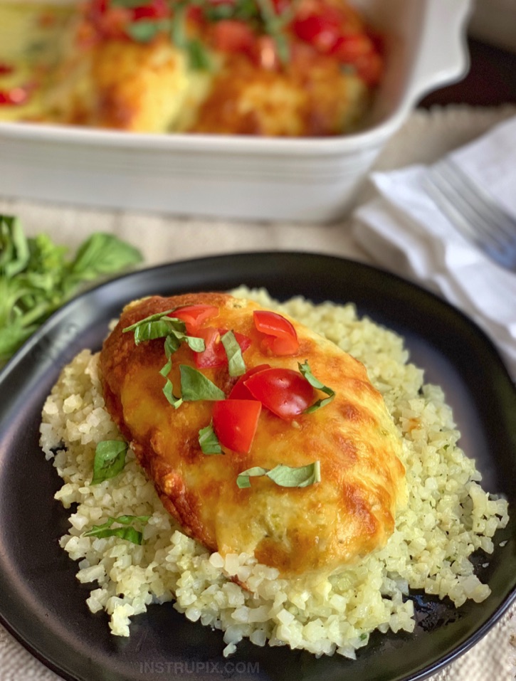 Low Carb Cheesy Pesto Chicken served with Cauliflower rice! So good, the entire family will love it! Super quick and easy to make, too. 