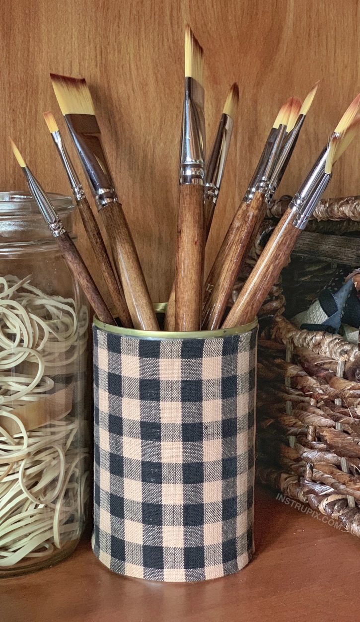 Fabric Covered Tin Can Makeover -- A cheap and easy craft project anyone can make! These are great for home organization, especially for an office or craft room. I use mine as a brush holder. This is Upcycling that doesn't suck.