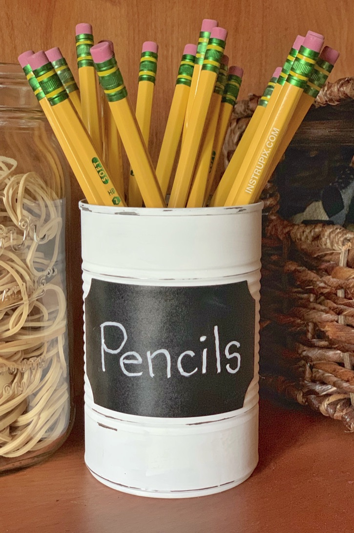 DIY Tin Can Makeover -- 6 fun and easy ways to upcycle a tin can! Great for office organization and much more! This cheap and easy craft idea is great for both kids and adults to make. This one is made with just paint and a chalkboard sticker. 