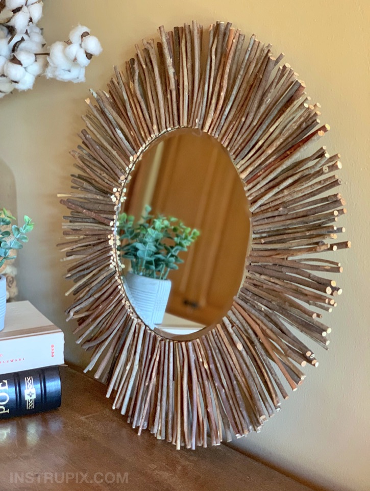 DIY Stick Framed Round Mirror -- made with cardboard and hot glue. Cheap and easy!