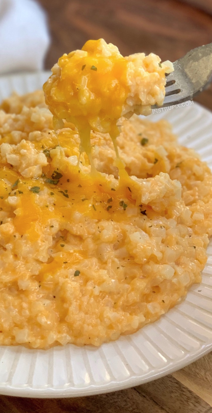 Quick and easy keto side dish recipe: Low Carb Cheesy Cauliflower Rice made with cheddar, butter, cream cheese, milk and garlic. The best frozen cauliflower rice recipe! #instrupix #lowcarb #keto