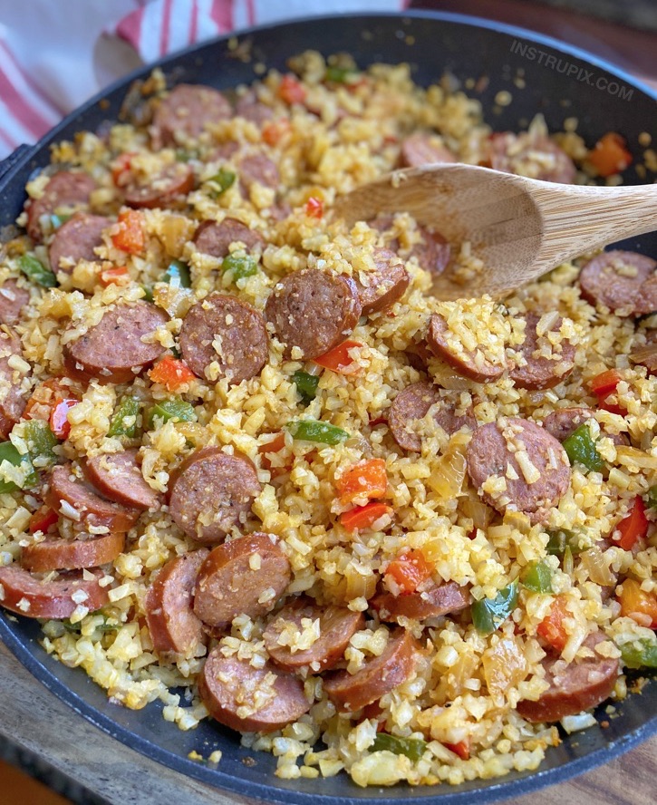 Cajun Cauliflower Rice -- Quick, easy and healthy keto dinner recipe made with simple ingredients in just one pan: frozen cauliflower rice, sausage, bell pepper, onion, cajun seasoning and oil. Delicious keto and low carb meal idea!