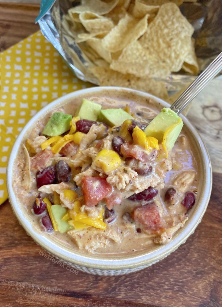 Cheap and easy weeknight meal! Slow Cooker Creamy Chicken Chili -- Made with simple and cheap ingredients even your picky eaters will love.