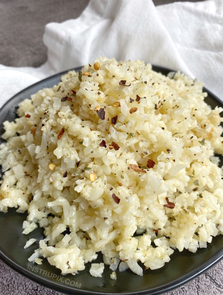 Keto Garlic Parmesan Cauliflower Rice -- So quick and easy to make thanks to frozen cauliflower rice! My favorite low carb side dish for dinner.