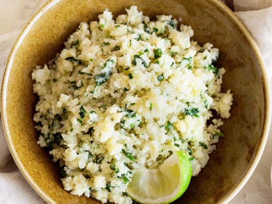 Cilantro Lime Cauliflower Rice -- This low carb side dish goes well with any Mexican inspired meal! It's quick and easy to make with frozen cauliflower rice.