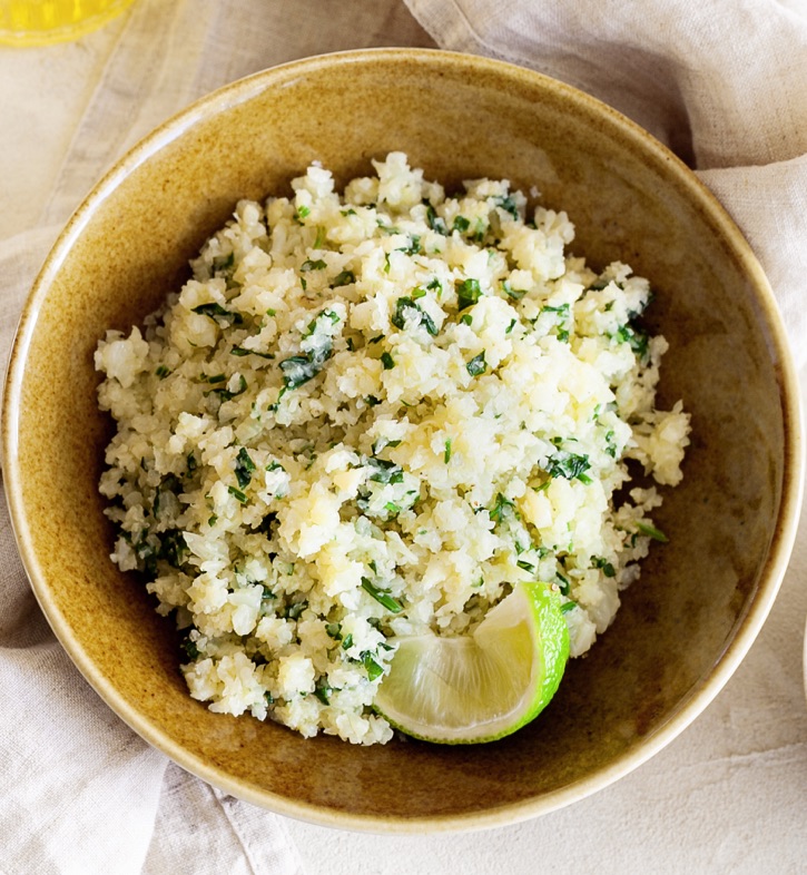 Cilantro Lime Cauliflower Rice -- This low carb side dish goes well with any Mexican inspired meal! It's quick and easy to make with frozen cauliflower rice.