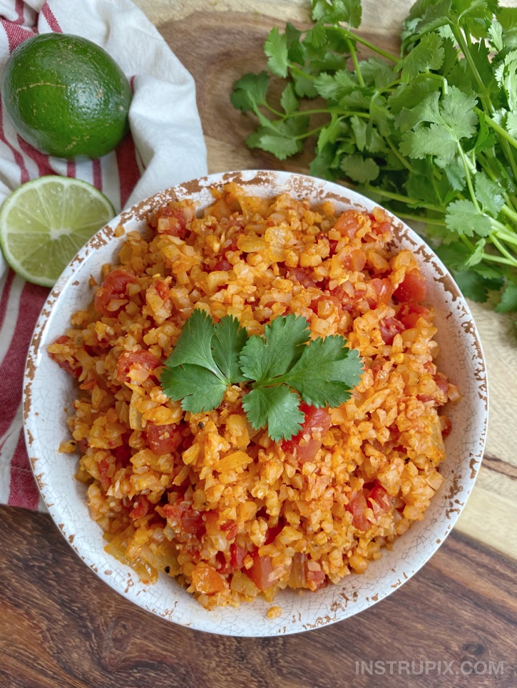 Easy Spanish Cauliflower Rice Recipe (made with frozen cauliflower rice!) So simple, healthy and yummy. This low carb side dish recipe pairs really well with any Mexican inspired dinner, and is quick to throw together for busy weeknight meals.