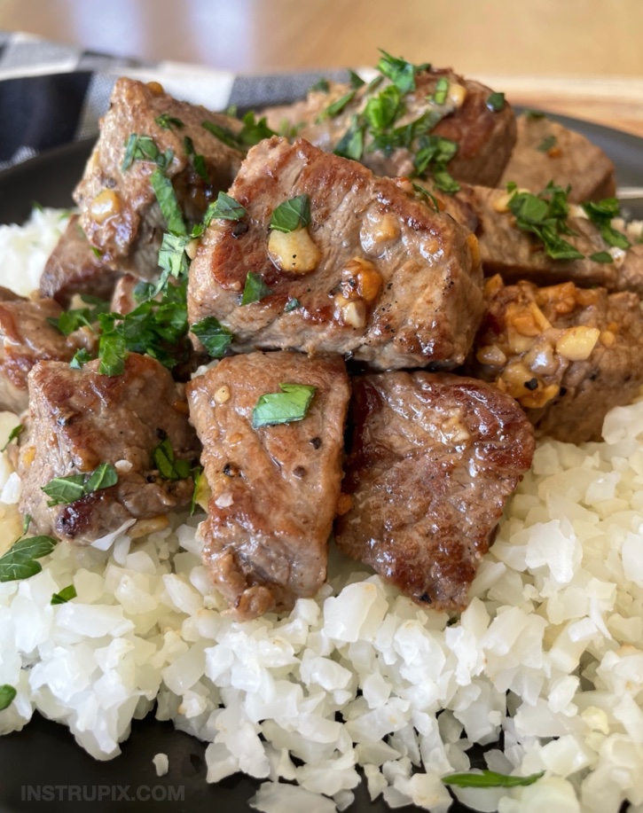 Steak Bites with garlic butter! A super quick and easy low carb dinner recipe. Serve with a healthy side of vegetables like frozen cauliflower rice. Super simple! Steak is really fast to make in a cast iron skillet on your stovetop. 