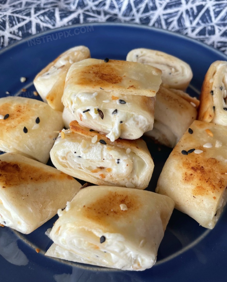 Looking for fun and easy finger food ideas? These crispy bagel bite snacks are so quick and easy to make! My teenagers love making them. I use low carb tortillas because I'm watching my carbs, but any flour tortillas will work. Sprinkle with everything bagel seasoning for savory flavor. 