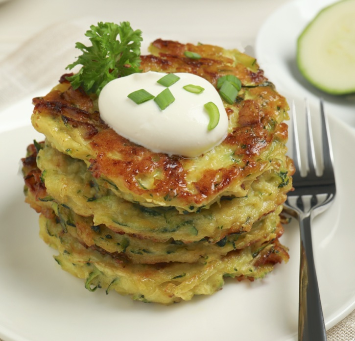 Easy keto zucchini fritters made with just a few ingredients! This healthy and low carb snack is super quick and easy to make with zucchini, almond flour, parmesan cheese, eggs, and seasoning. Fry them on your stovetop in a pan for the best little keto snack!