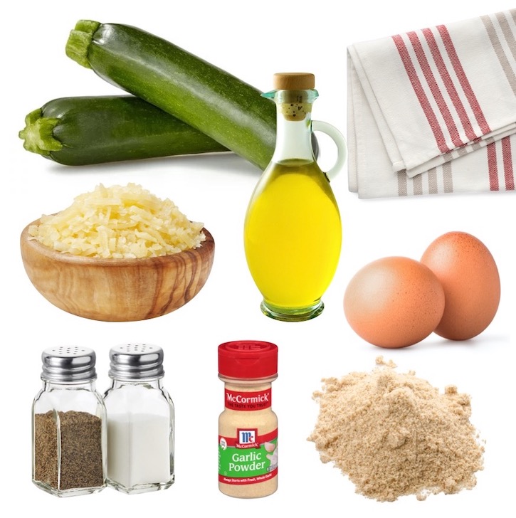 Ingredients for making keto zucchini fritters including zucchini, egg, almond flour, parmesan cheese, olive oil, and seasoning.