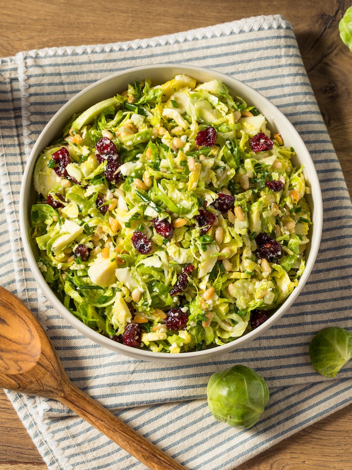 Delicious Homemade Brussels Sprouts salad with a quick and easy salad dressing! Toss it with your favorite salad ingredients including toasted nuts, cheese, fruit and more!