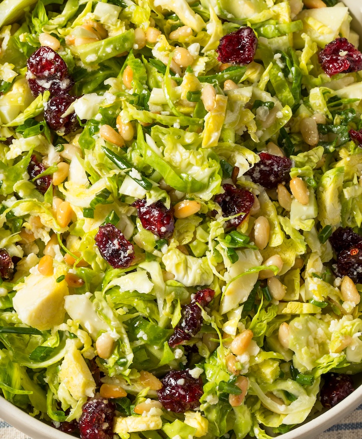 Shaved Brussels Sprouts salad with a lemon olive oil dressing, feta cheese, pine nuts and dried cranberries. A delicious and healthy side dish! 
