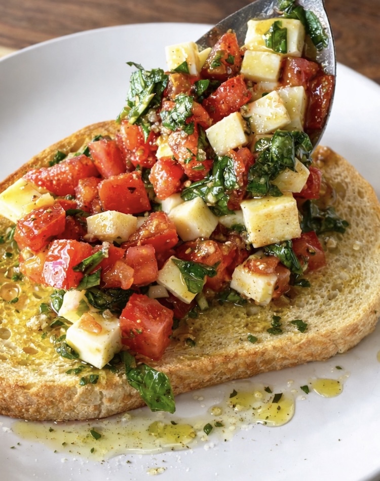 Toasted sourdough topped with a mixture of mozzarella, tomatoes, fresh basil, garlic, and olive oil.