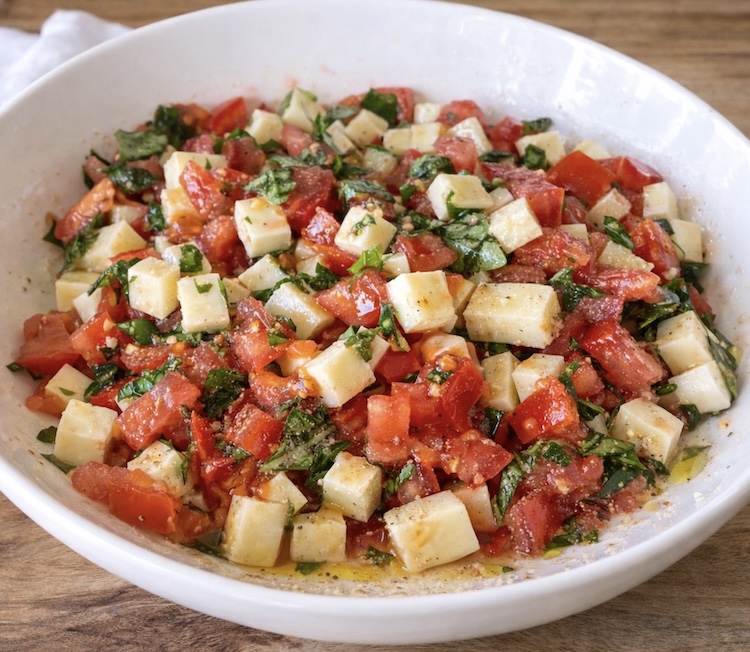Step 2 How to make Caprese Toast: Toss ingredients with olive oil, garlic, and black pepper. 