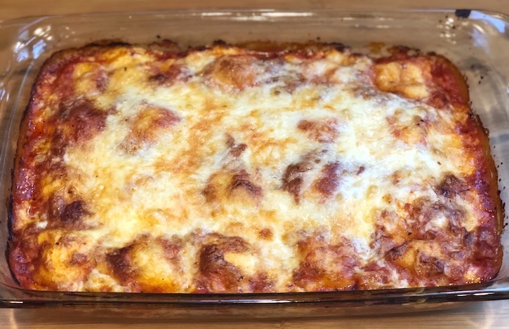 Top view of a cheesy baked ravioli casserole recipe made with just 3 ingredients, also known as LAZY LASAGNA. 
