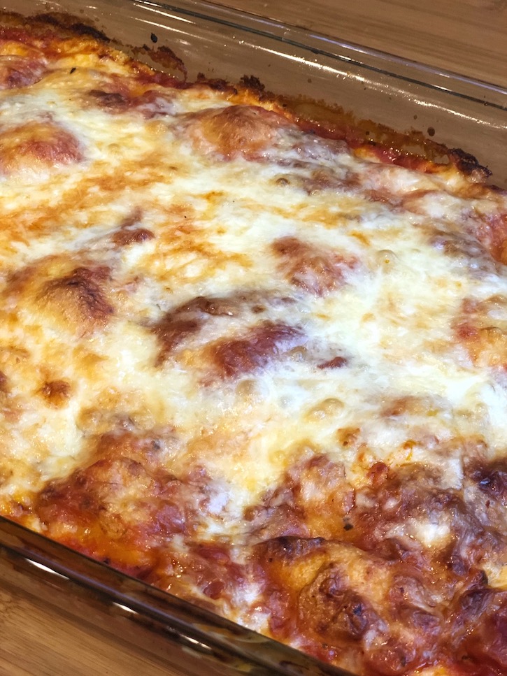 A golden brown cheesy dinner casserole made with just a few ingredients including frozen ravioli, pasta sauce, and shredded mozzarella cheese. You can also sprinkle on some grated or shredded parmesan for extra cheesiness!
