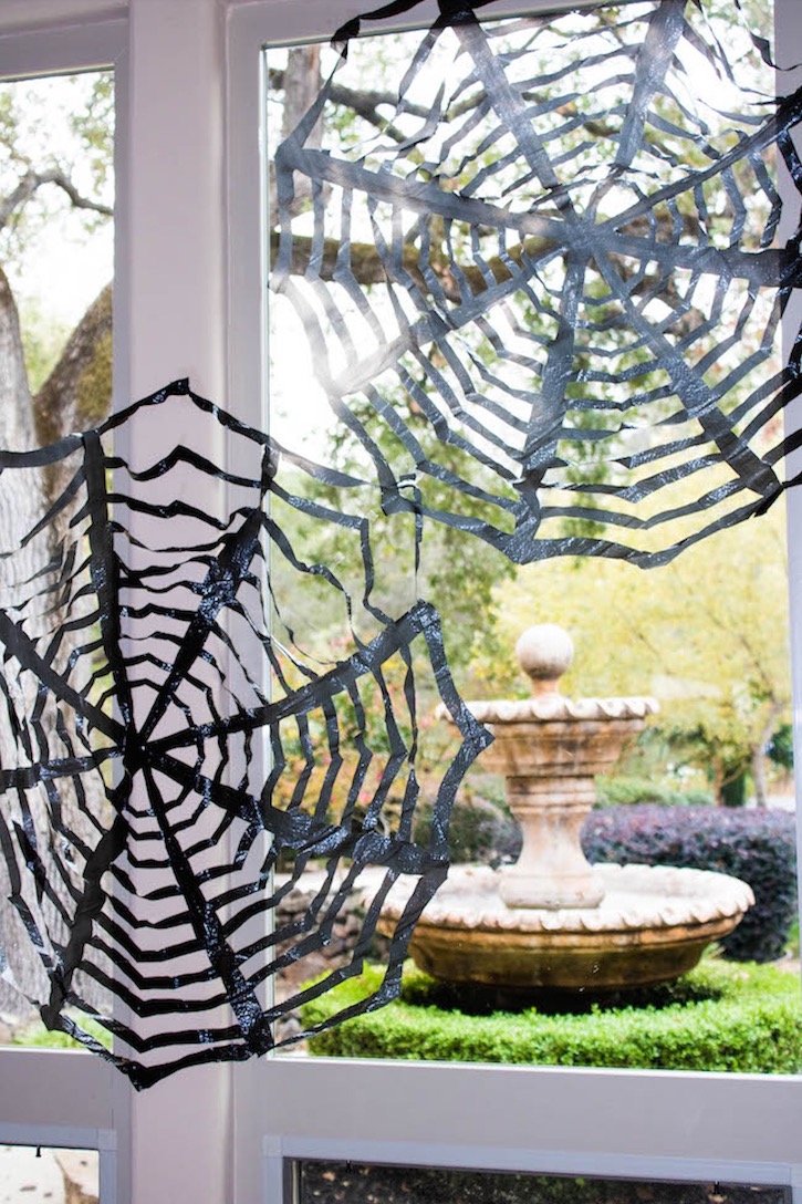 Cheap and easy DIY Halloween decor made with trash bags! A full tutorial on how to make creepy spiderwebs out of trash bags for both indoors and outdoors on your front porch. 