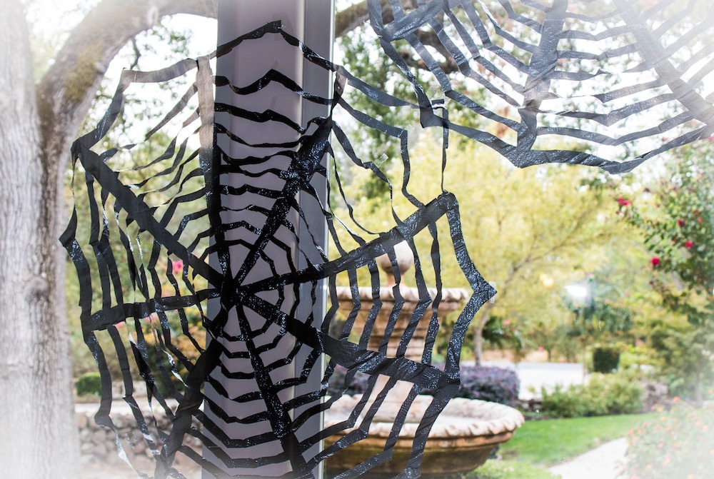 DIY Cheap Halloween Decoration made with trash bags! A full tutorial with pictures and videos on how to make spiderwebs.