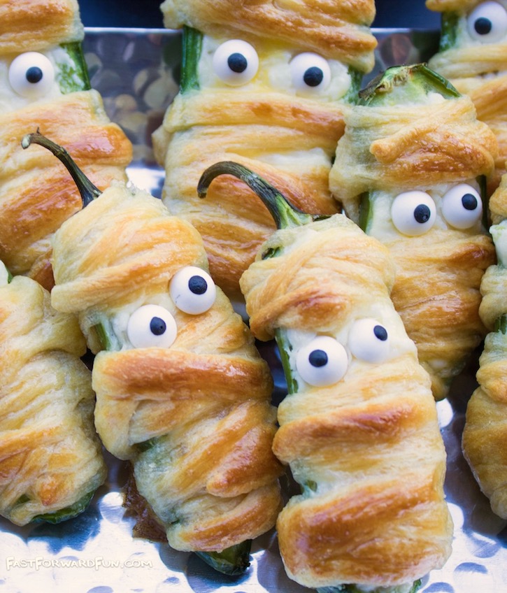 Close up of a super cute Halloween appetizer called Jalapeño Popper Mummies. An easy party snack for adults during the spooky season!