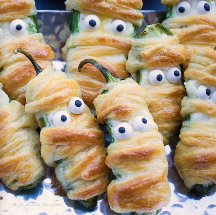 The best Halloween food idea for parties! These jalapeno mummies are a delicious appetizer for adults made with peppers, cream cheese and Pillsbury crescent dough. 