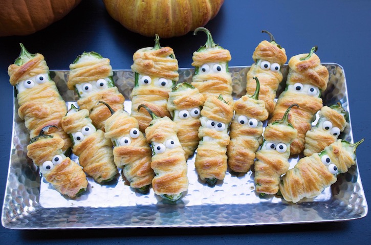 If you're on the hunt for Halloween party food ideas, these yummy yet spooky jalapeno popper mummies are a crowd pleaser!