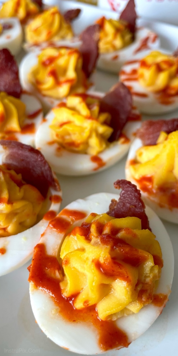 Chick-fil-A Sriracha Deviled Eggs with Bacon! A fun twist on classic deviled eggs made with Chick-fil-A sauce instead of mayo. This spicy and sweet appetizer is a huge hit at parties! Especially if you're serving a crowd. I make them every year for Easter and they are always the first thing to disappear on the appetizer table. 