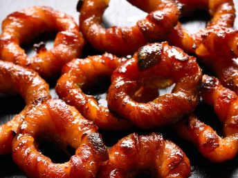 Delicious oven baked or air fried bacon onion rings brushed with bbq sauce.