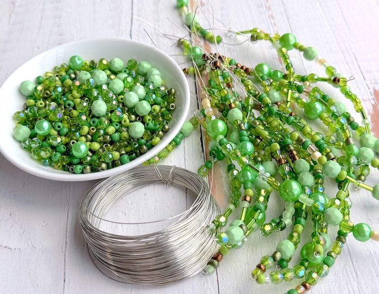 variety of green beads and 26 gauge jewelry wire for making beaded plants. 