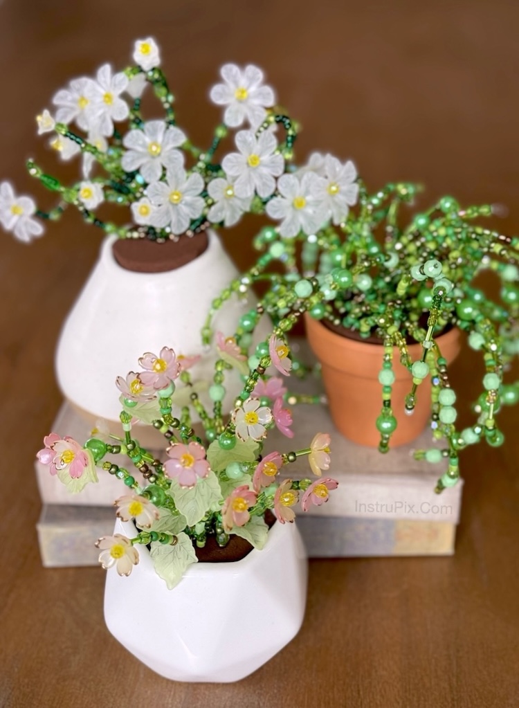 Variety of beaded plants on a table, a DIY craft project using jewelry beads, small pots, and foam. Lots of step by step instructions included with photo tutorials. 