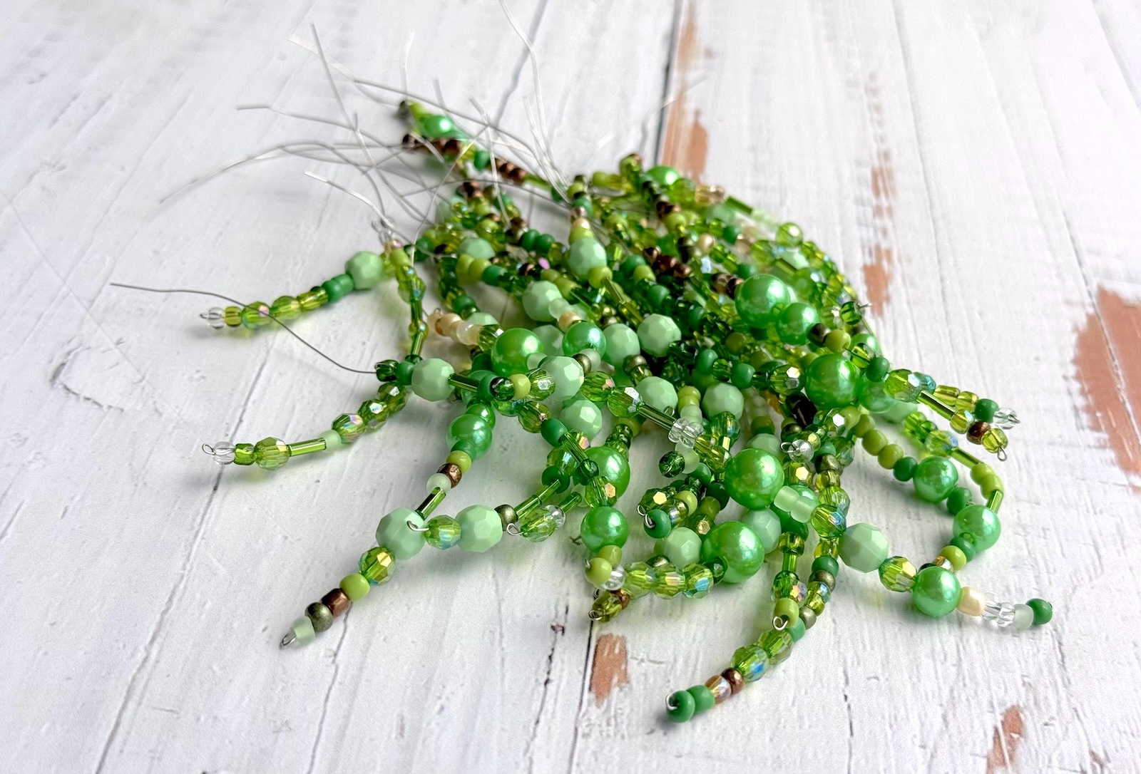 Green beaded wired stems for making a craft plant. 